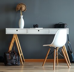 A white desk with wooden legs and an Eames chair is set against the dark grey wall, creating a modernist aesthetic