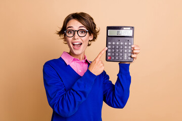 Photo portrait of lovely young lady point excited calculator dressed stylish blue garment isolated...