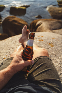 Unrecognizable man holds a beer in summer
