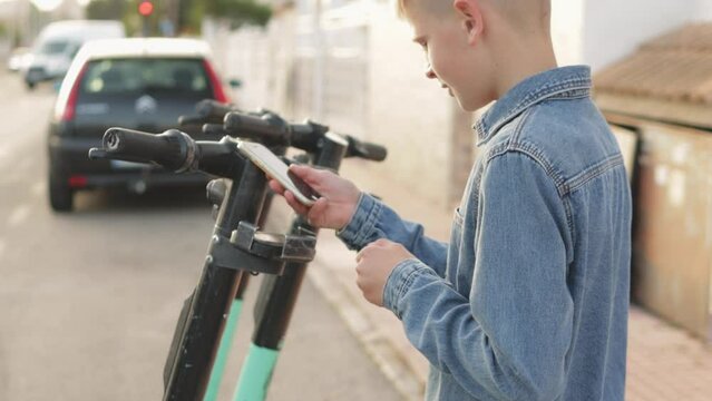 teenager unlocks and pays for an electric scooter using their phone app, ready to explore  city's tourist attractions. Highlighting the convenience of app-based payments and e-scooter 