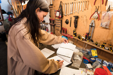 Female mechanic doing paperwork at workshop