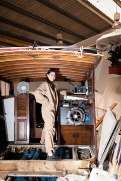 Confident female mechanic during boat reparation process