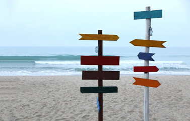 Colorful wooden traditonal direction sign by the beach