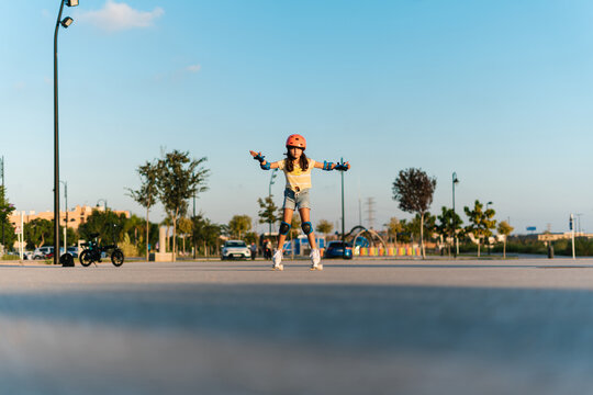 Girl learning riding roller skates in park