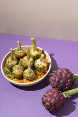  French artichokes à la Barigoule or Carciofi alla provenzal. Provencal artichokes stewed with carrots, onions, white wine, bay leaves and Provencal herbs. Spring recipes from southern France. Lavende