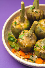  French artichokes à la Barigoule or Carciofi alla provenzal. Provencal artichokes stewed with carrots, onions, white wine, bay leaves and Provençal herbs. Spring recipes from southern France. Lavende - 770927865