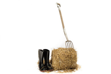 a pitch fork stuck into a bale of straw in a barn © SockaGPhoto