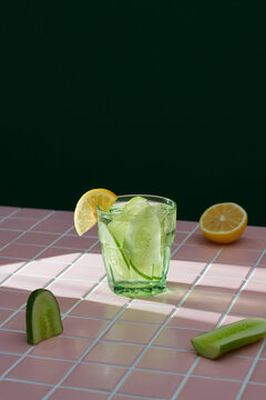 Collage with cucumber water on green backgrounds. Infused water