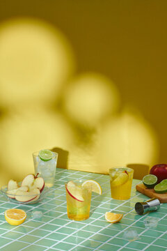 Apple cider or juice drink and apples on turquoise mosaic table