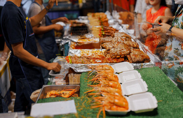 Thai street food on night market. Seafood 