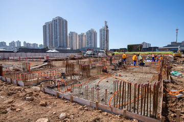 Construction workers during installation of steel gratings for the foundation of a building. Sao Paulo, Brazil