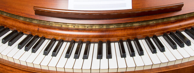 a circular distorted view of an old rosewood piano keyboard