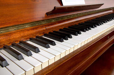 a close up angle view of all of the keys on a  rosewood piano keyboard  