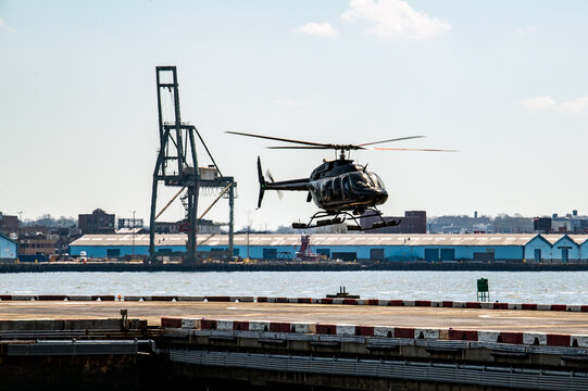 Helicopter hovering over industrial port