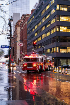Firetruck in rainy Manhattan street.