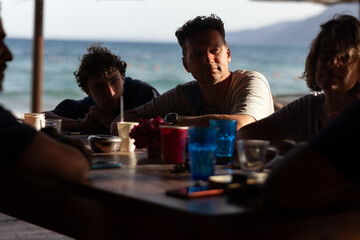 Family sitting in beach cafe
