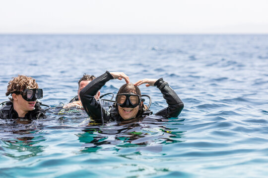 Woman scuba diver showing OK sign with her arms