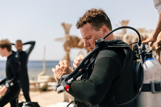 Scuba Diver checking his gear before a dive
