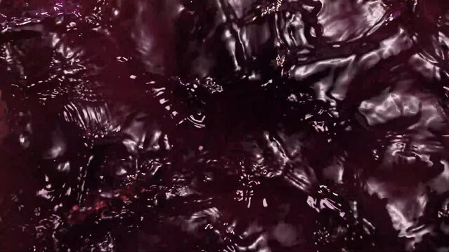 Splashes of red wine and cherry juice in slowmo