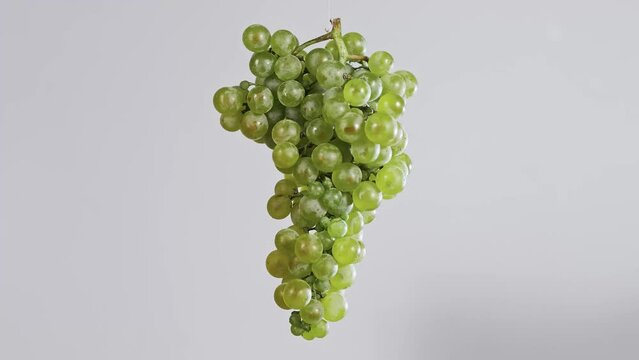 Bunch of white grapes on a white background rotate