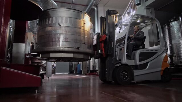 Forklift truck places basket in wine press