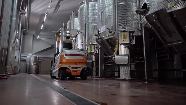 Forklift truck with driver through wine production
