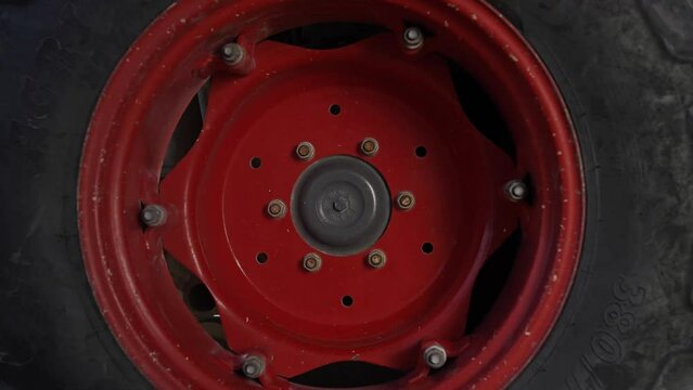 Spinning a big red farm tractor wheel with offroad