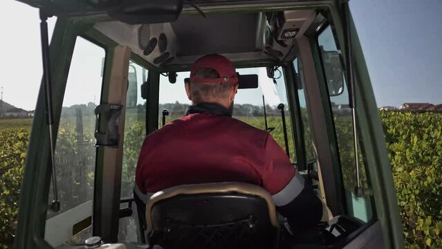 Driver in the cab of an agricultural tractor 