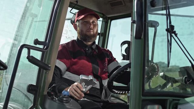 Agricultural driver in the tractor cab 
