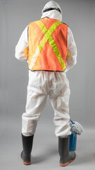 an unidentified person likley a man in a hazmat suit with rubber gloves and rubber boots with a...