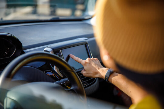 Woman searching for directions while using GPS navigator in car