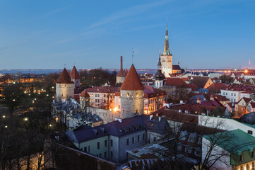 Tallinn cityscape with Saint Olaf's church and old town walls and towers at sunset, Estonia