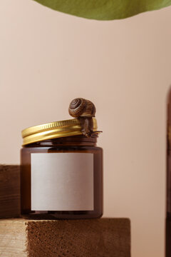 a mock-up of a jar with candles and a snail