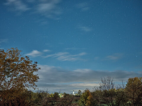 Autumn night landscape with forest area and church