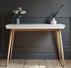 White desk with light wood legs against dark gray walls