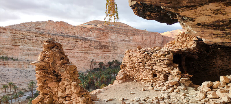 The balconies of Ghoufi, ancient Berber village, with stone and clay houses, carved into waterfalls in the rock, and the river which waters the oasis of palm trees and fruit trees. Batna. Algeria