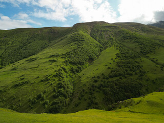  fantastic fantasy landscape, green grassy mountain hills - aerial drone shot.