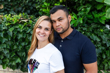 multiracial marriage of latin man and blonde caucasian woman outdoors