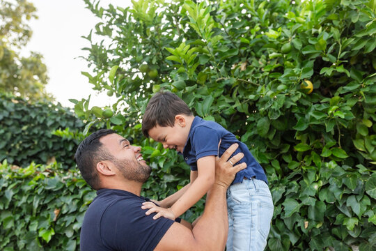 latin father with little son playing outdoors