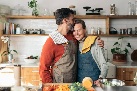 Couple Embraced in Love while Cooking Together
