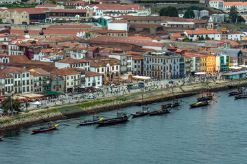 Aerial drone view of the Douro River and the Porto promenade with the old houses, rabelas, classic...