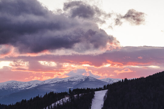 Dramatic orange sunset on ski resort Bukovel in Ukraine.