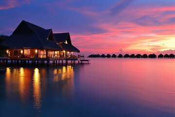 Fototapeta premium Tropical resort with overwater bungalows at sunset