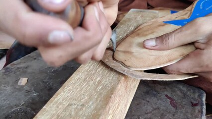 Skilled Cobbler Crafting Leather Sole with Precision