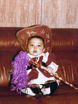One-Year-Old in Carnival Costume on Home Sofa