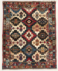 a carpet with an intricate geometric pattern in red, blue and beige. The center of the rug features symmetrical designs that resemble triangles or other basic shapes