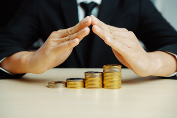 Businessman working with coin money currency. Concept of investment growth and money saving. uds