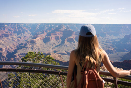 A woman observes the Grand Canyon from a scenic viewpoint