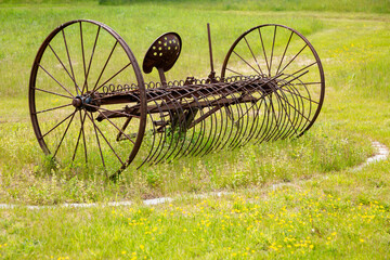 Fototapeta na wymiar Old farm equipment in grassy area