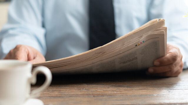 businessman reading newspaper at office